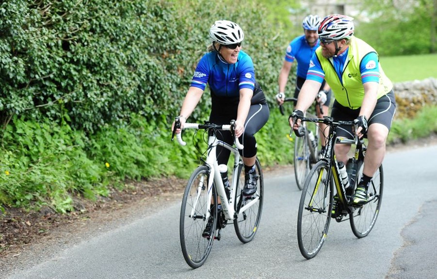 2 friends cycling and laughing