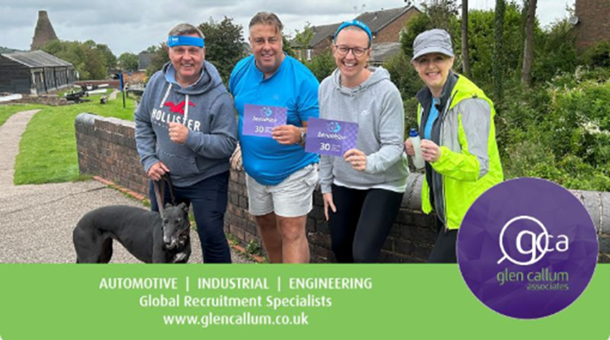 Four Glen Callum Associates colleagues with a dog on a canal towpath, holding Benathlon 30-day challenge cards, with the text "Automotive | Industrial | Engineering, Global Recruitment Specialists, www.glencallum.co.uk" and the company logo.