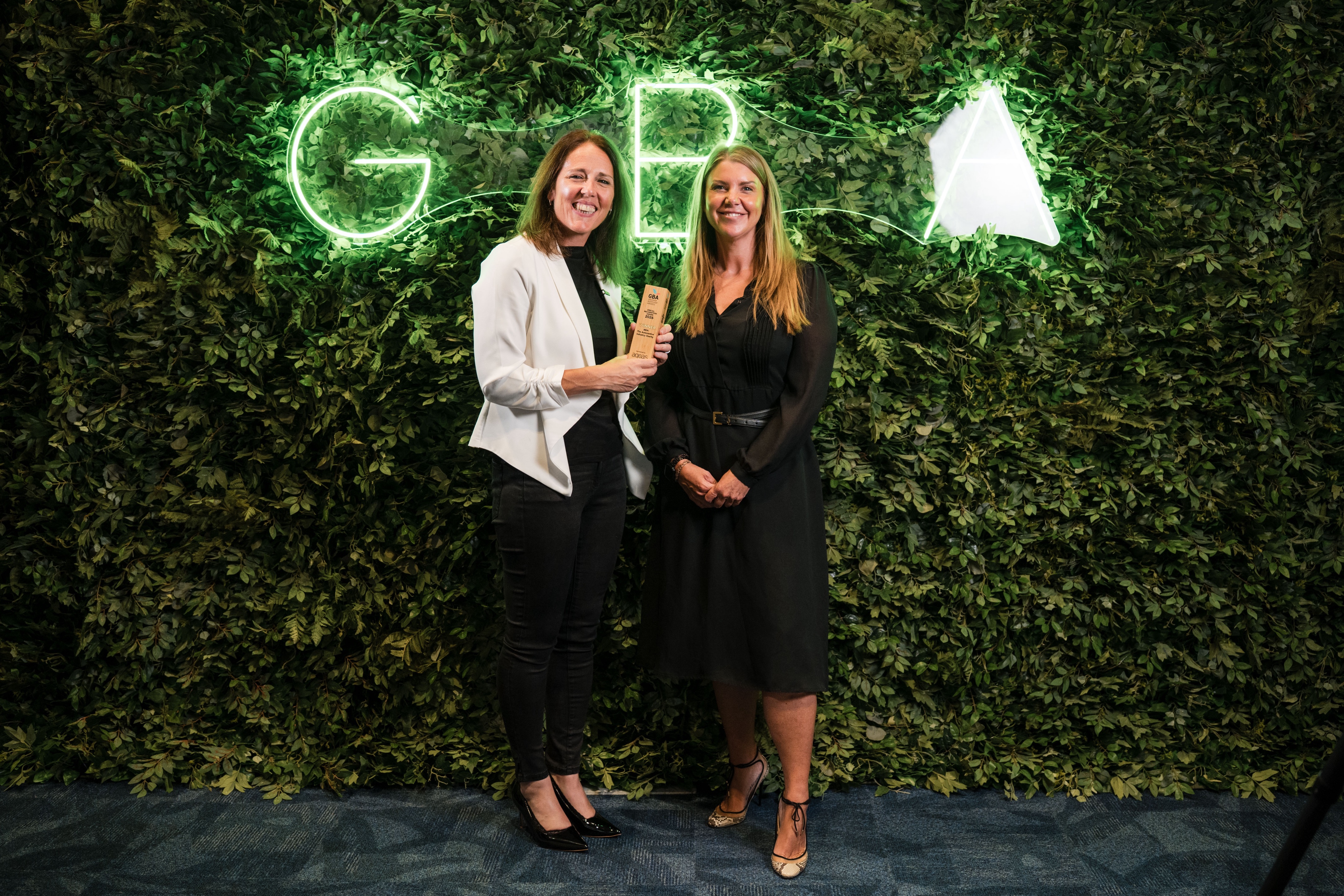 Ben's CEO Rachel Clift and Head of Awareness & Experience Ellen Plumer holding a trophy at the Greener Bodyshop Awards