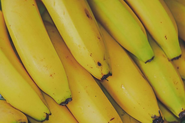 rows of overlapping ripe yellow bananas 