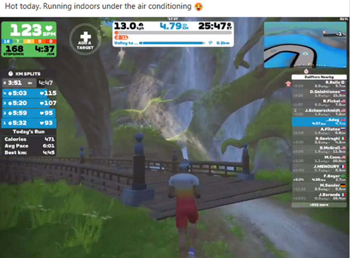 Screenshot of a virtual running app showing an avatar jogging over a bridge in a jungle setting, with stats for heart rate, pace and kilometre splits, captioned "Hot today. Running indoors under the air conditioning".