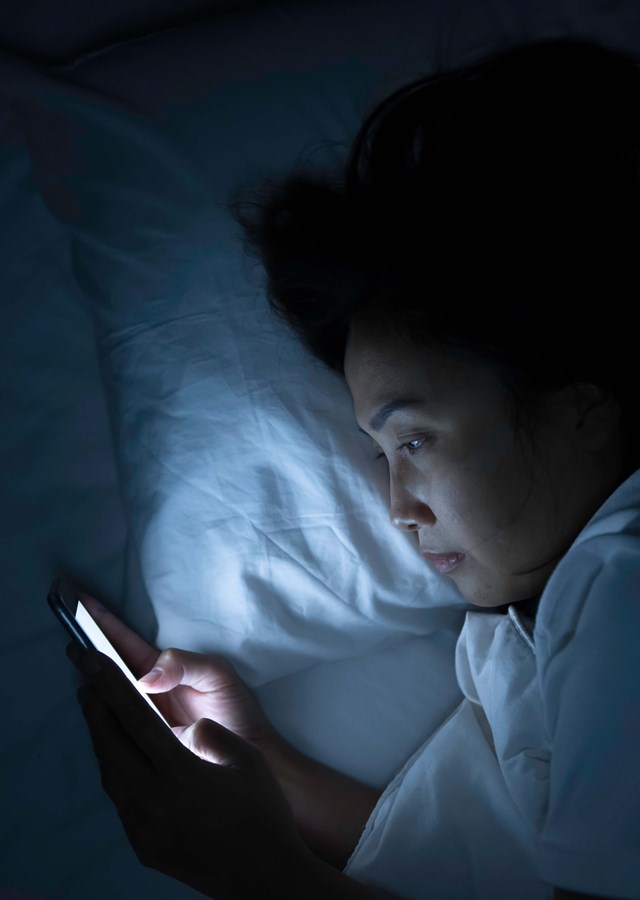 Person texting on their mobile late at night