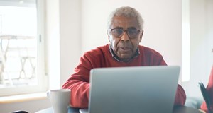 A person researching useful resources for bereavement on a laptop