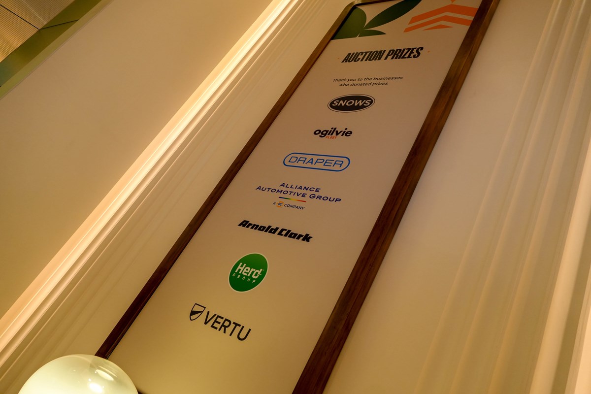 Banner headed "Auction Prizes" thanking the businesses who donated: Snows, Ogilvie Fleet, Draper, Alliance Automotive Group, Arnold Clark, Herd Group and Vertu.