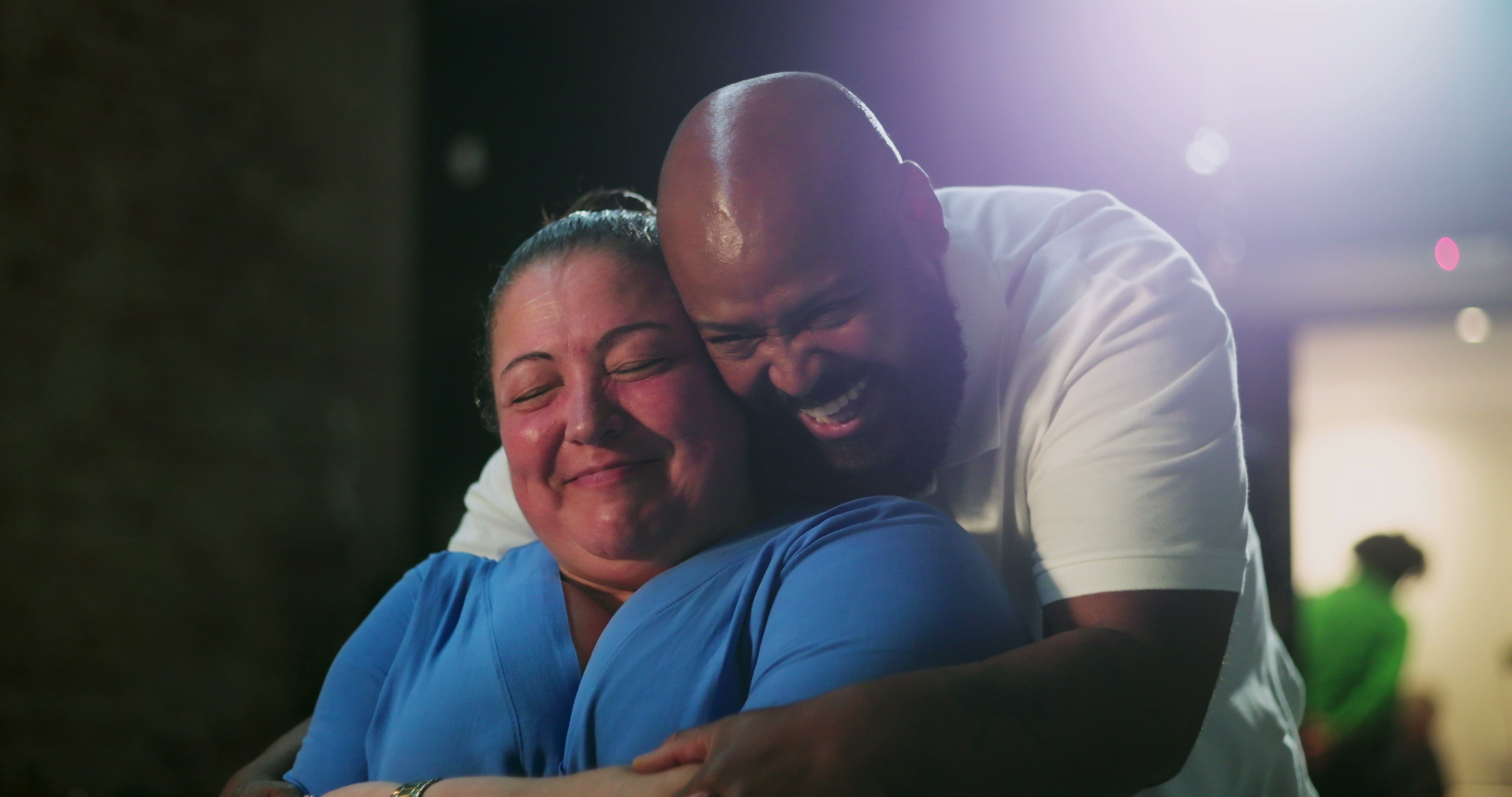 Man and woman smiling and hugging