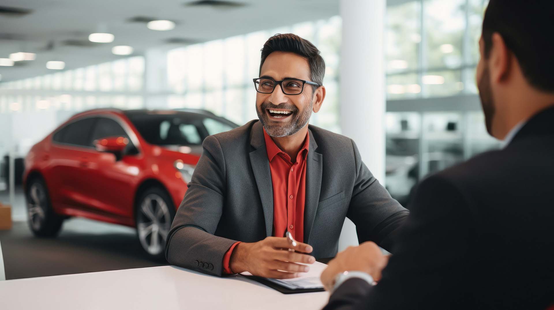 Customer signing documents in car dealership