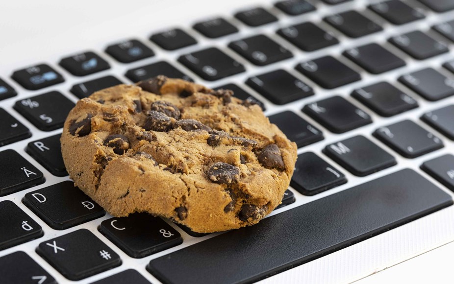 Chocolate chip cookie sat on a keyboard