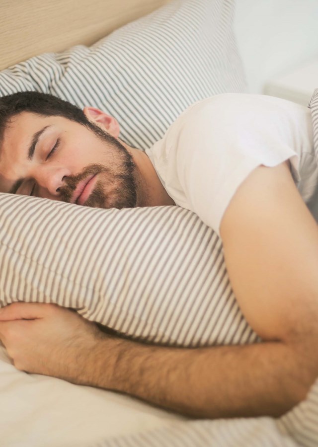 Man in deep sleep. Improving your sleep as a shift worker. Getting sleep at any point during the day