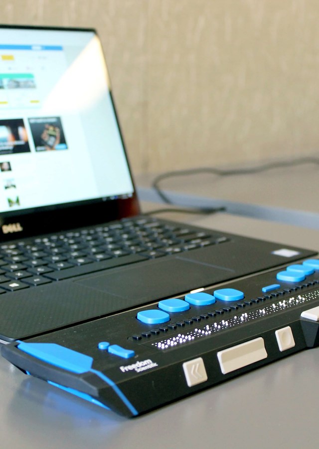 Image of a laptop with a connected accessibility device to help navigate a website
