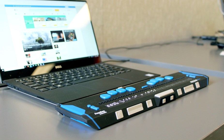 Image of a laptop with a connected accessibility device to help navigate a website