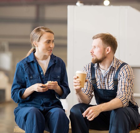 Two people sitting having a coffee catching up and checking in on each other