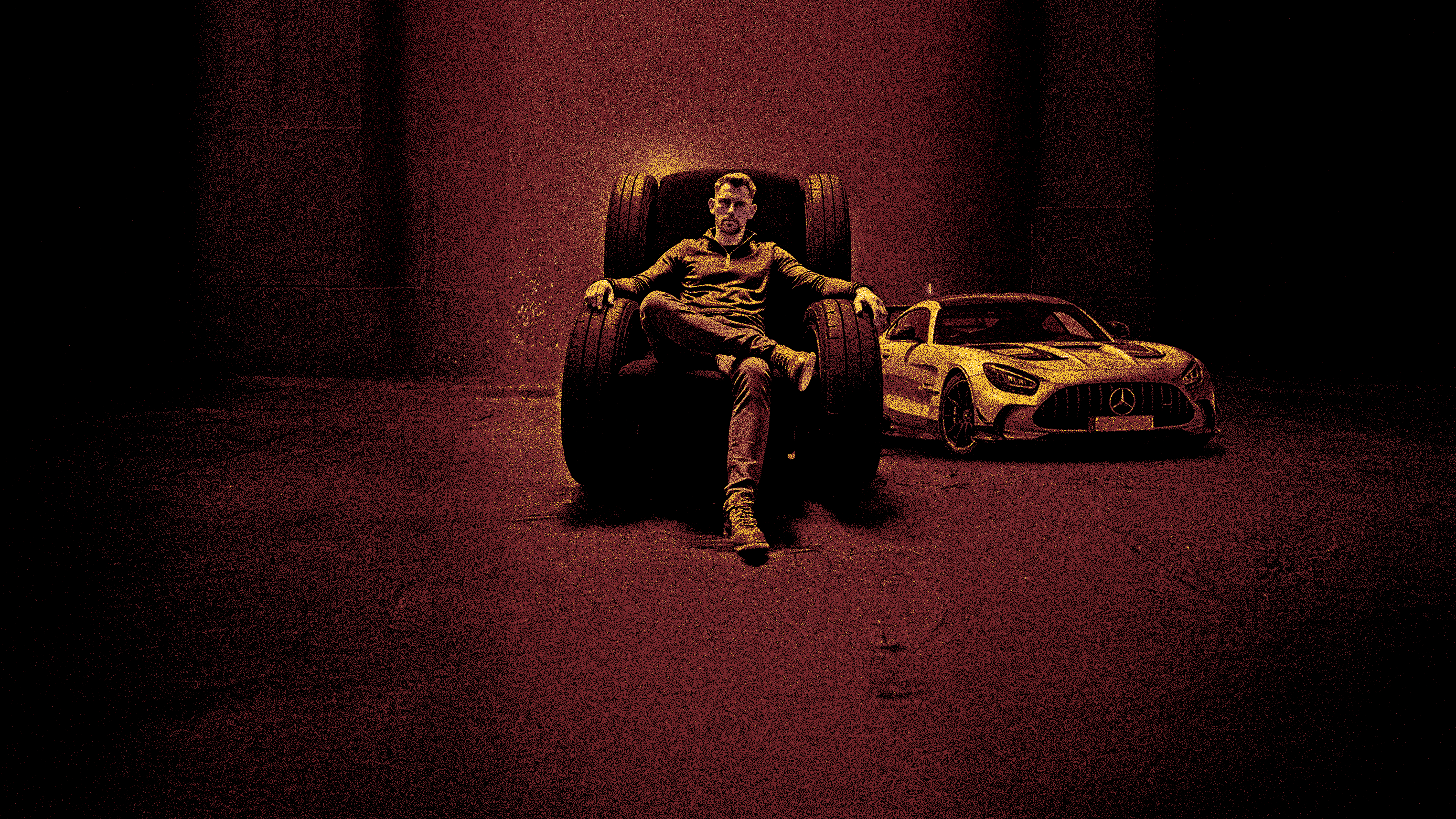 Nathan Taylor, Managing Director of Walsall Wood Tyre & Service, sat in an armchair with Mercedes AMG GT-R race car next to him. Yellow text reads "Race tyre to race track, Trade up series". With Ben support for life logo at the bottom