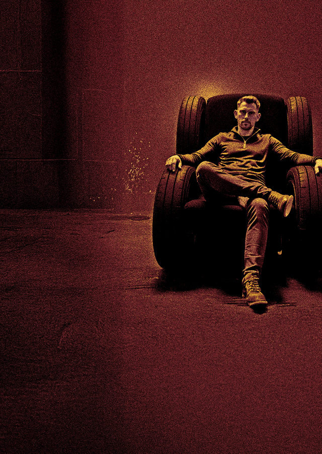 Nathan Taylor, Managing Director of Walsall Wood Tyre & Service, sat in an armchair with Mercedes AMG GT-R race car next to him. Yellow text reads "Race tyre to race track, Trade up series". With Ben support for life logo at the bottom