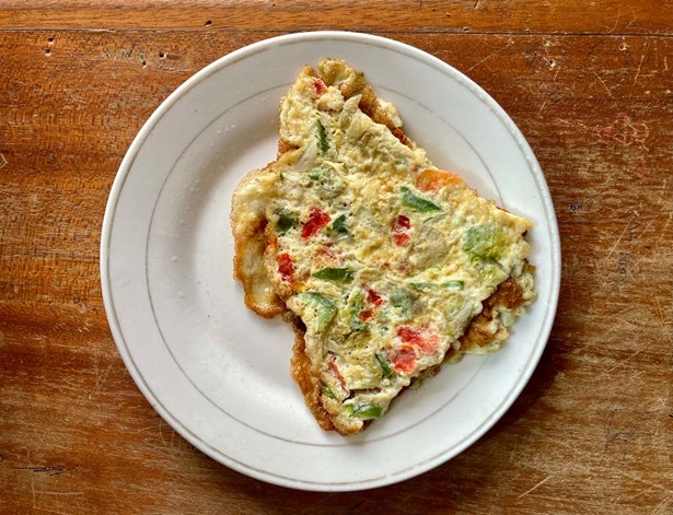 folded vegetable omelette sitting on a white plate