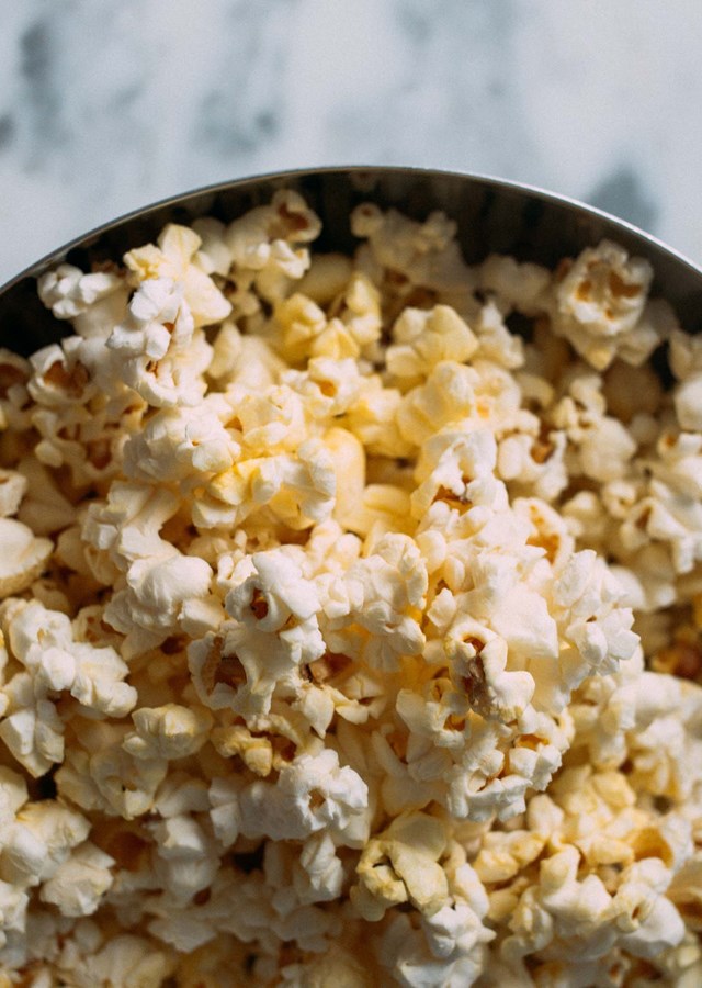 A large bowl of popcorn sitting on a table for a healthy snack