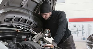 Garage technician looking at a car engine to diagnose issue. Demonstrating skills that can be used in other job roles, sectors and industries.