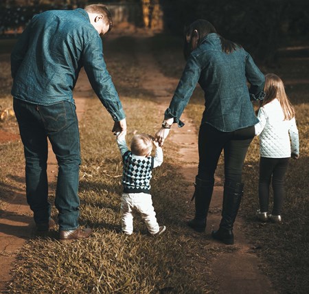 A family spending time together walking down a path
